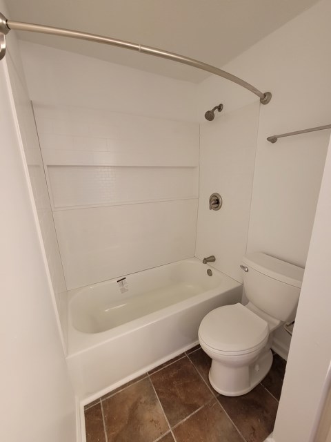 Renovated bathroom with new bathtub and surround and new vanity with granite countertops