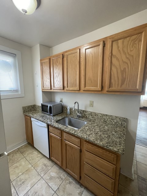 Kitchen with brand new full sized Stainless Steel Refrigerator, dishwasher, oven, granite countertops