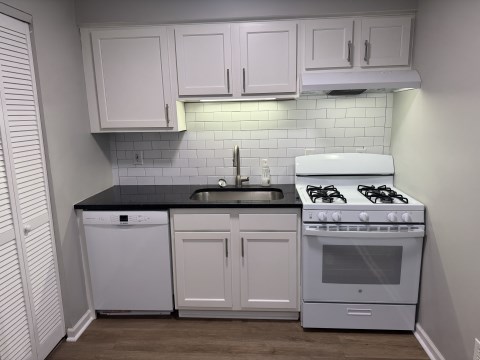 Renovated kitchen w/ granite countertops subway tile back splash