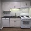 Renovated kitchen w/ granite countertops subway tile back splash